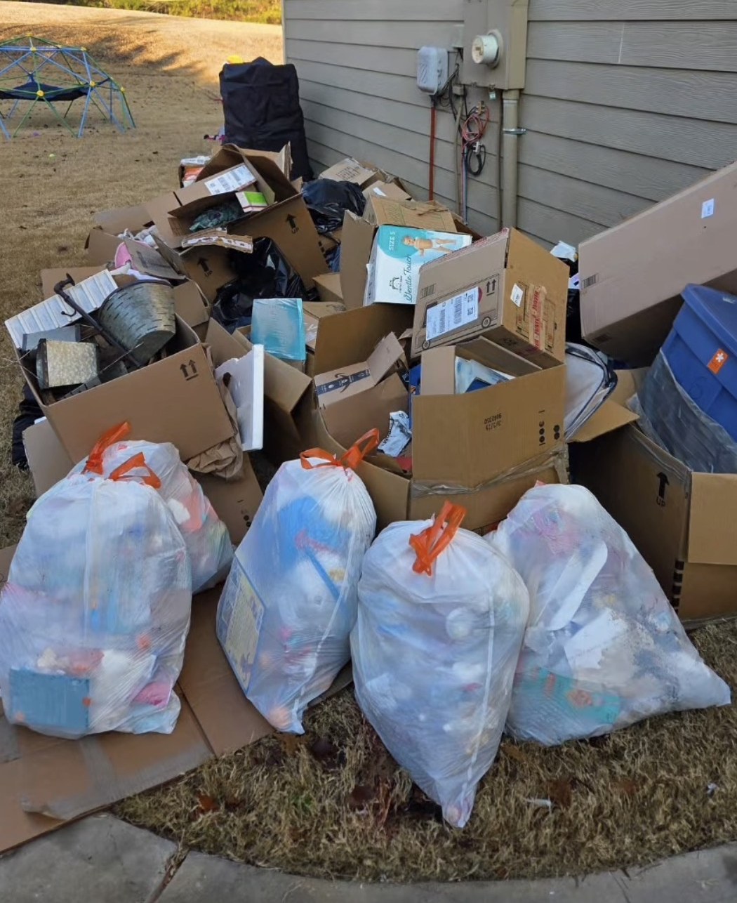 Boxes, bags, and household junk outside a home before removal